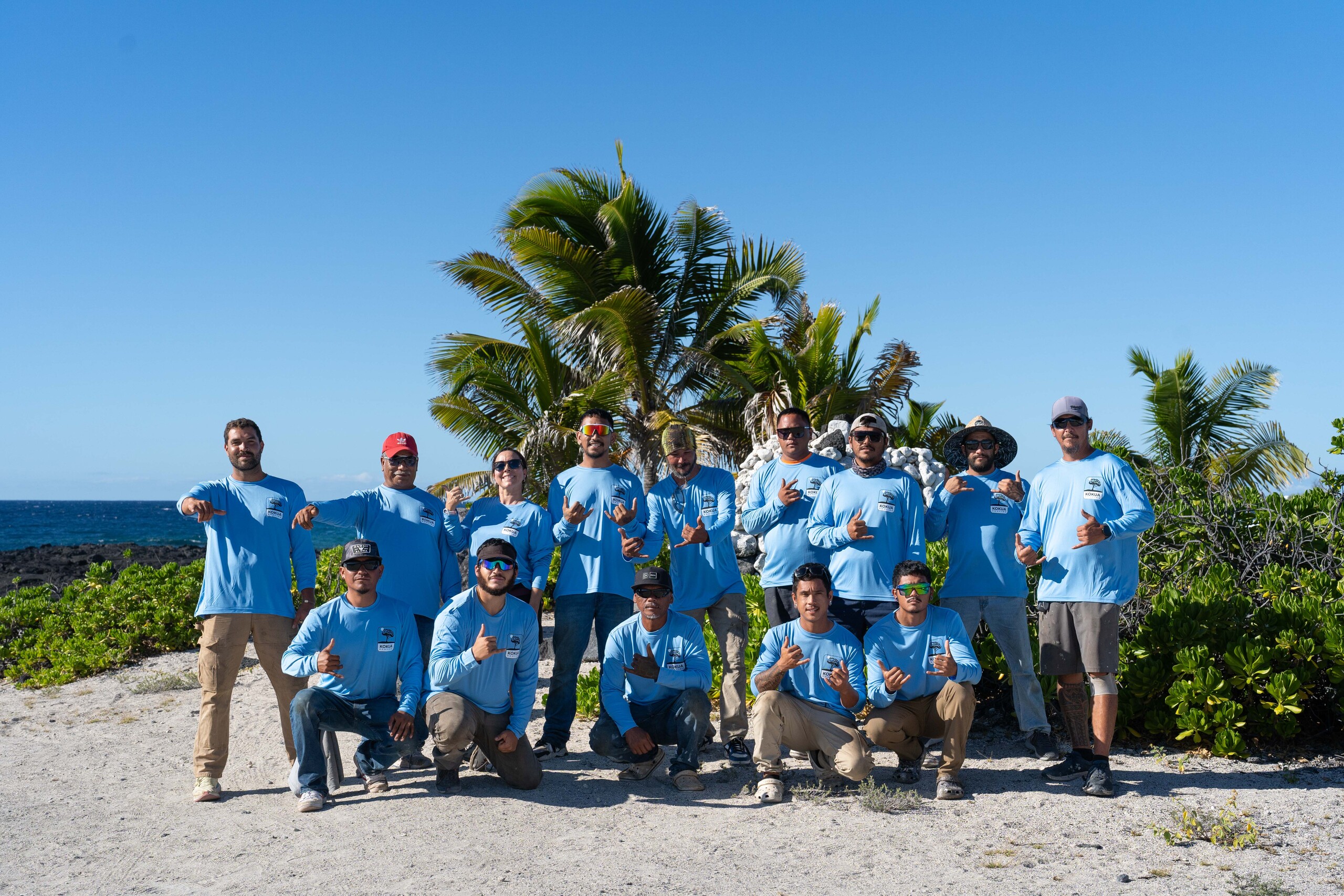 Group photo of Kokua Roofing workers on the beach