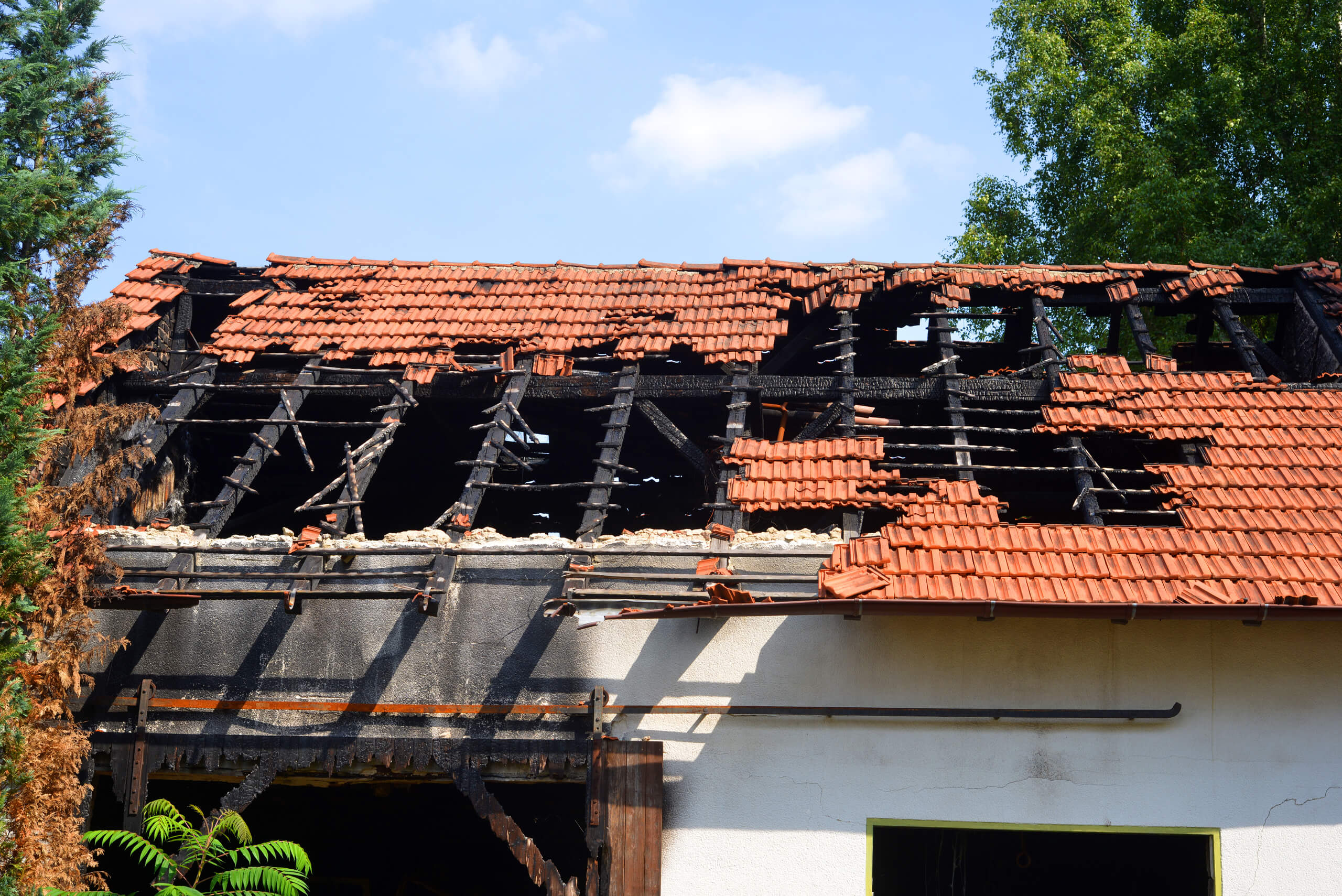 A photo of a home with some major wind and fire damage.